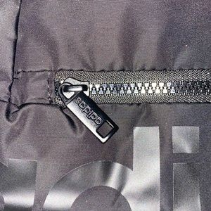 Adidas mini sports bag with two pockets with a neon pink accent color